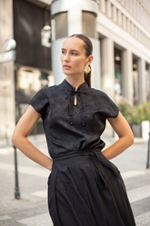 a lady in a black jacquard qipao dress and a black mamianqun